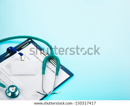 Medical Questionnaire, Stethoscope And Empty Id Tag On Blue Background