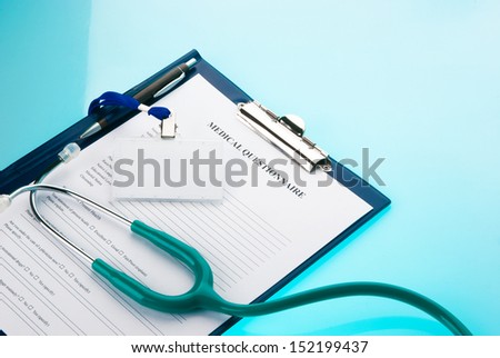 Medical questionnaire, stethoscope and empty ID tag on blue background