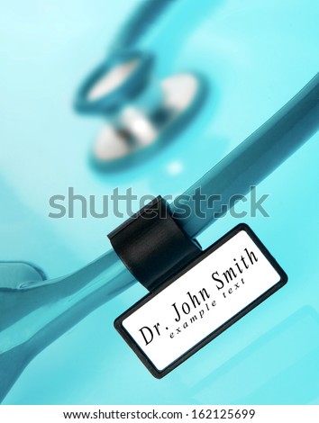 Stethoscope with medical ID tag on blue background