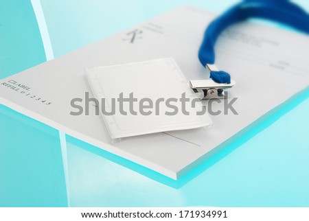 Empty ID tag and medical prescription on blue, reflective background