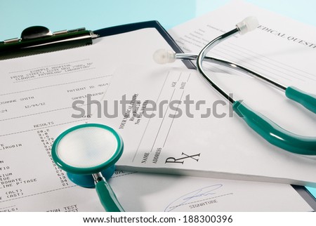 Medical documents (medical questionnaire, prescription and blood test) with a stethoscope on blue background