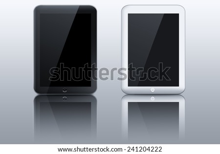 Two black and white tablet pc computers on reflective table