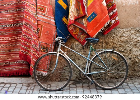 Old bicycle and traditional carpets on the street of Marrakesh, Morocco