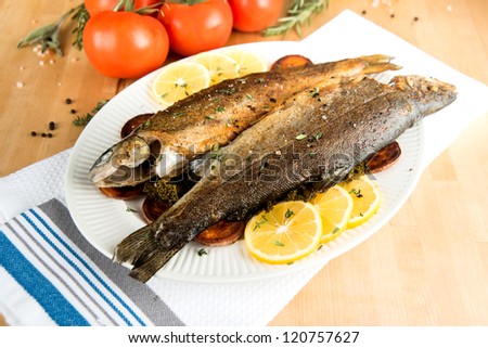 Two Whole Rainbow Trouts Fried and Served with Vegetables