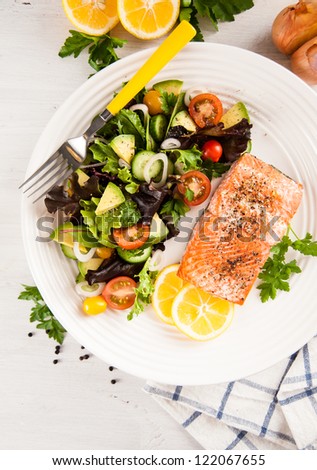 Baked Salmon Served with Tomatoes, Cucumbers, Avocado, Greens Salad