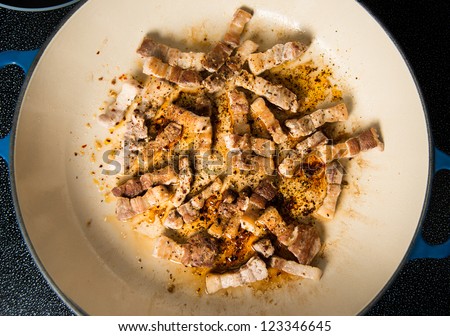 Pork Belly Pieces Sauteed in Enamel Skillet with Herbs and Spices