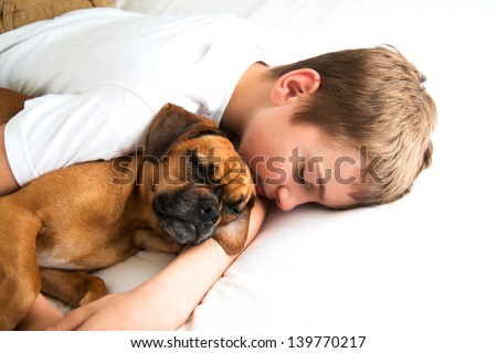 Young Boy Fell asleep Hugging his Dog