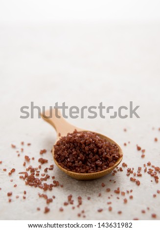 Red Hawaiian Sea Salt in Bamboo spoon on Table