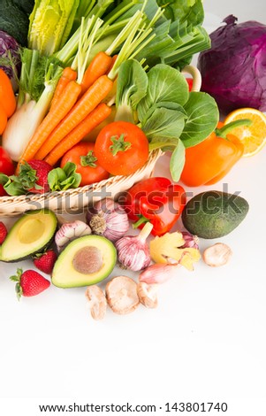 Closeup of Fresh Vegetables and Fruits in Basket on White Background