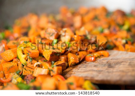 Sweet Potato Hash with Fresh Herbs, Peppers and Onions Cooking in Skillet