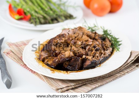 Cooked Pork Loin Roast with Balsamic Vinegar and Honey Reduction Served with Asparagus
