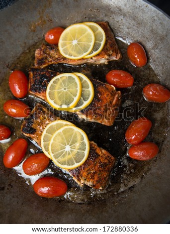 Wild Salmon Fillets on Skillet with Cherry Tomatoes