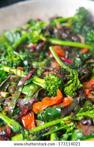 Young Organic Broccolini Lightly Cooked with Zucchini, Onions, Cranberries, and Greens for Healthy Meal