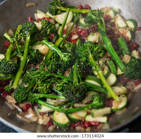 Young Organic Broccolini Lightly Cooked with Zucchini, Onions, and Cranberries for Healthy Meal