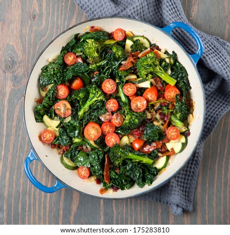 Broccolini, Cherry Tomatoes, Italian Kale, and Onions Sauteed in Skillet for Healthy Meal