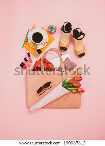 Large Simple Pink Woman\'s Business Briefcase with Various Items, Coffee Cup and Tulip Bouquet  on Pink Background