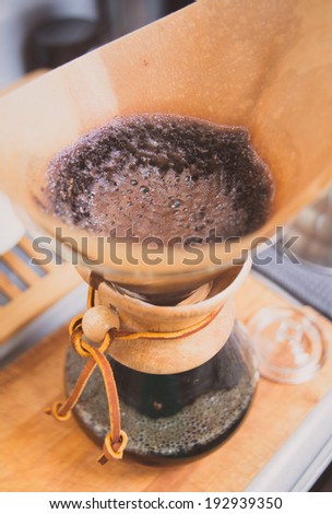 Glass Carafe with Ground Coffee Beans in Brown Paper Filter for Pour Over Style