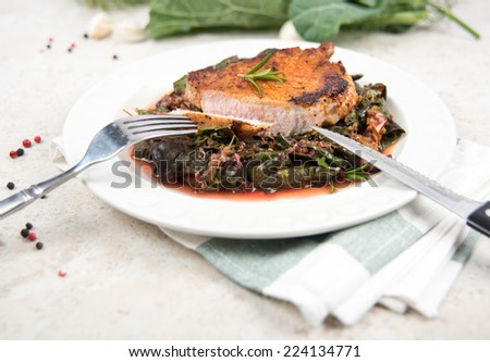 Boneless Grilled Pork Chop Served with Wilted Rainbow Chard and Collard Greens