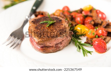 Yellow Chanterelle Mushrooms Cooked in Butter and Wine with Cherry Tomatoes Served with Medium Rare Filet Mignon