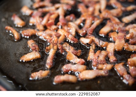 Sliced Bacon Pieces on Skillet Being Cooked