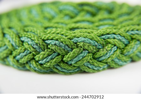 Roll of Green Woven Rope Isolated on White