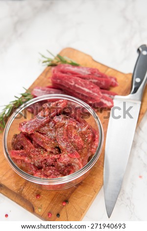 Grass Fed Flank Steak Sliced and Mixed with Marinade to Make Beef Jerky