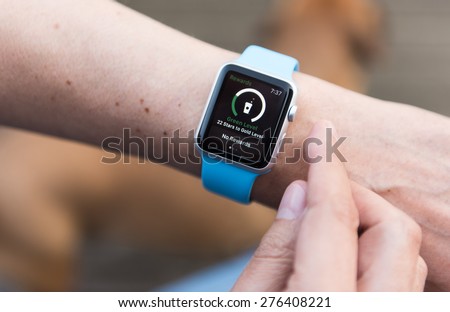 SEATTLE, USA - May 8, 2015: Man Using Starbucks App on Apple Watch to Check Nearest Location and Points Balance on Card.