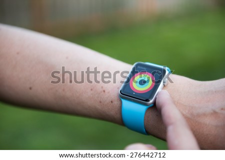 SEATTLE, USA - May 9, 2015: Man Using activity App on Apple Watch to See Calories Burned During Day.