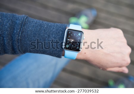 SEATTLE, USA - May 8, 2015: Man Using Watch App on Apple Watch to Check Time.