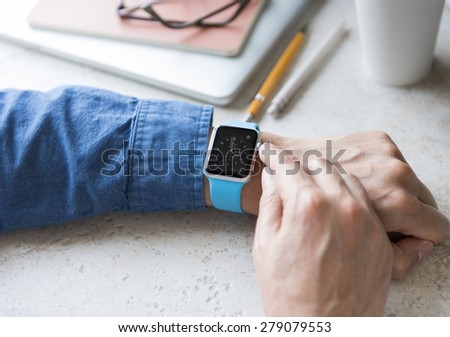 SEATTLE, USA - May 17, 2015: Man Wearing Sport Apple Watch with Blue Rubber Band.