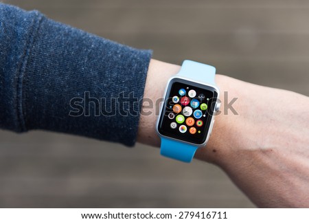 SEATTLE, USA - May 9, 2015: Man Using App on Apple Watch While Outside. Multiple Apps View.