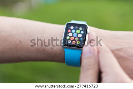 SEATTLE, USA - May 8, 2015: Man Using App on Apple Watch While Outside. Multiple Apps View.