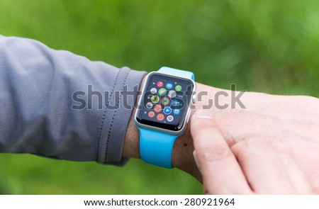 SEATTLE, USA - May 19, 2015: Man Using Apple Watch While Outside. Multiple Apps View.