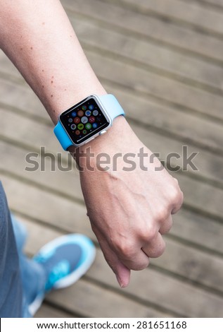 SEATTLE, USA - May 25, 2015: Man Using App on Apple Watch While Outside. Multiple Apps View.