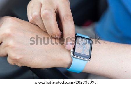 SEATTLE, USA - May 30, 2015: Man Using Maps App on Apple Watch While Driving Car