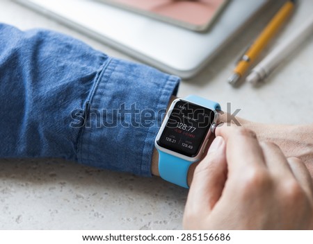 SEATTLE, USA - June 5, 2015: Man Wearing Sport Apple Watch with Blue Rubber Band.