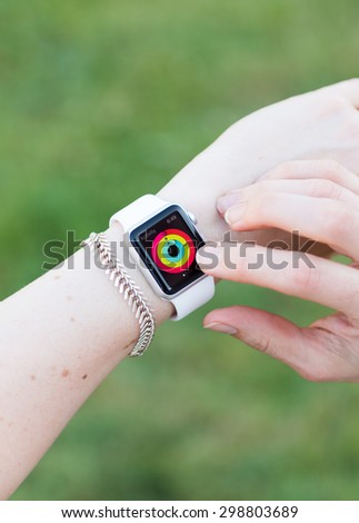 SEATTLE, USA - July 22, 2015: Woman Using Activity App on Apple Watch. Checking Progress and Goals Accomplished.