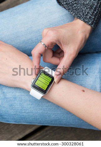 SEATTLE, USA - July 27, 2015: Woman Using Activity App on Apple Watch.