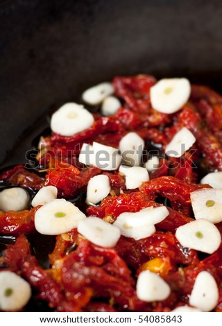 Sun Dried Tomatoes and Garlic in Cast Iron Skillet