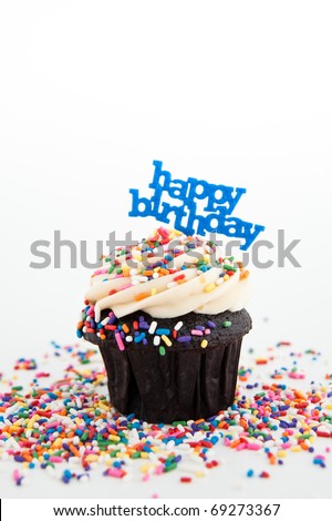 Festive Chocolate Cupcake Topped with Colorful Sprinkles and Happy Birthday Sign on White Background