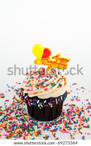 Festive Chocolate Cupcake Topped with Colorful Sprinkles and Happy Birthday Sign on White Background