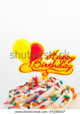 Festive Cupcake Topped with Colorful Sprinkles and Happy Birthday Sign on White Background