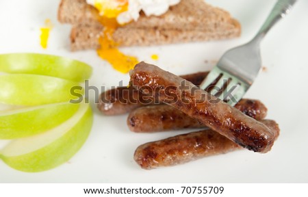Simple Traditional American Breakfast with  Sausages, Poached Egg and Whole Grain Toast