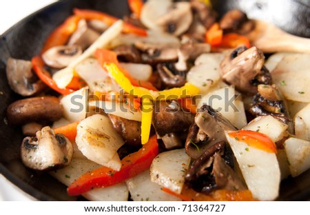 Sauteed  Mushrooms, Potatoes, and Bell Peppers in Cast Iron Skillet