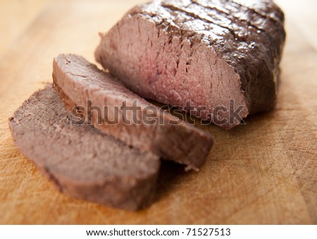 Organic Beef Sirloin Roast Sliced on Cutting Board
