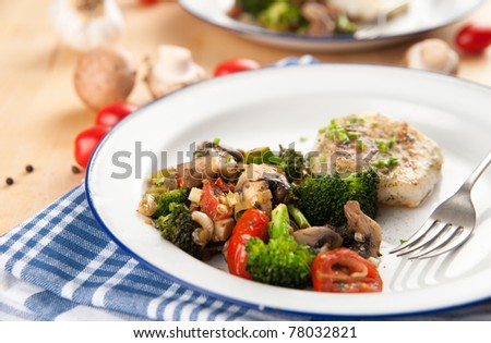Closeup of Dinner Plate with Grilled White Fish and Vegetables