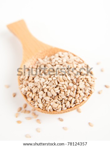 Sesame Seeds in Wooden Bamboo Spoon on White Background