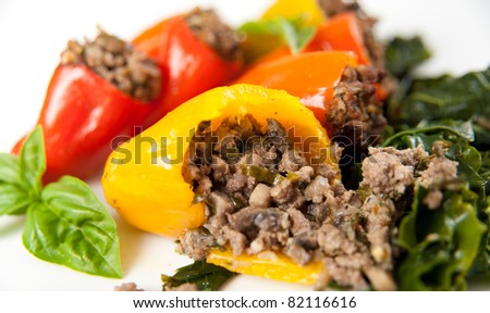 Beef and vegetables Stuffed Mini Bell Peppers Served on Wilted Collard Greens