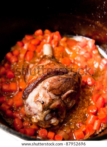 Lamb Shank Slow Cooked in Cast iron Pot with Carrots, Onions and Wine