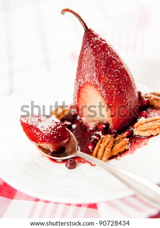 Simple Paleo Style Dessert Pear Poached in Pomegranate Juice Served with Nuts and Seeds
